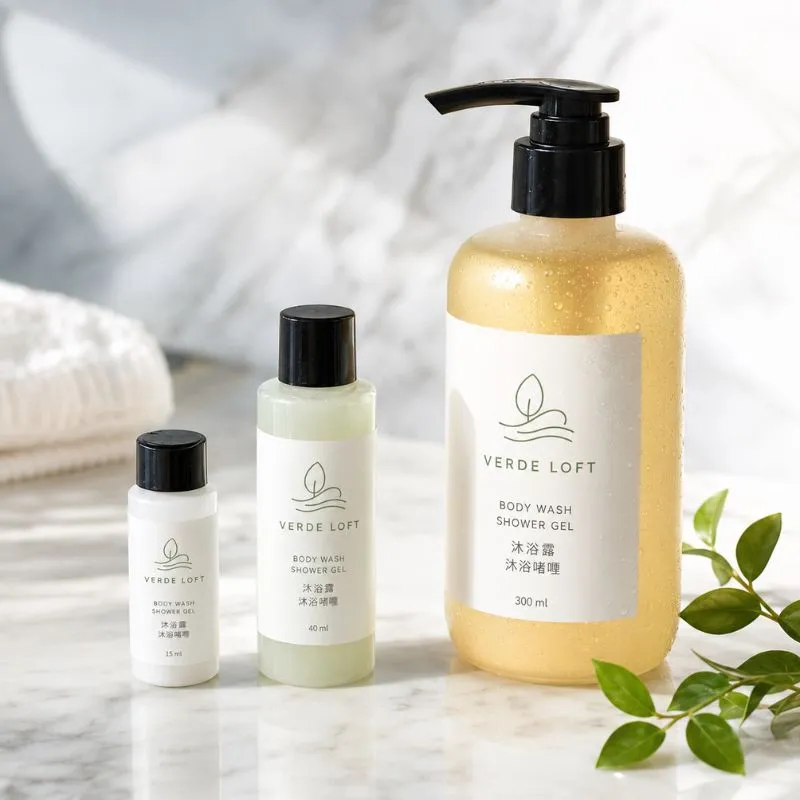 Hotel shower gel and body wash by UMYAN in 15ml, 40ml and 300ml bottles on marble — scented guest bath care