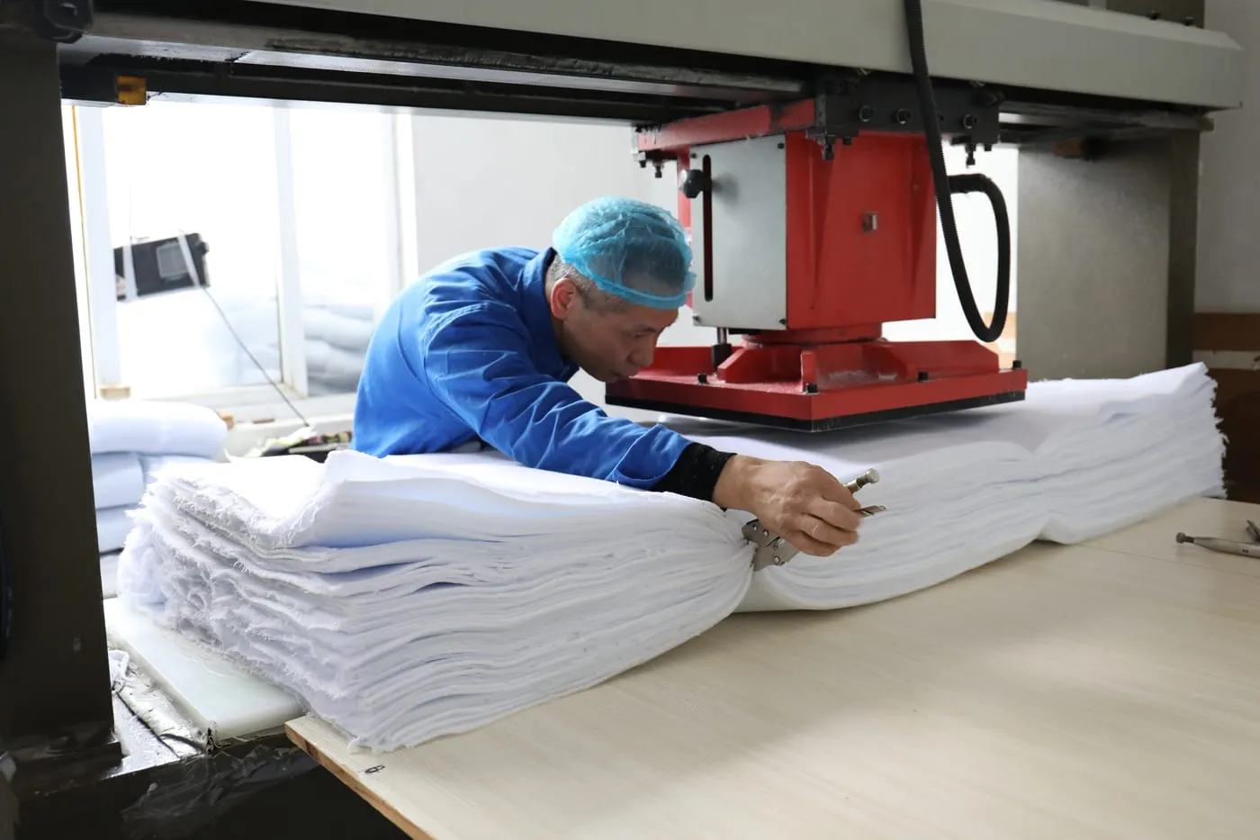 Hotel slipper production workshop — cutting the uppers on the die-press